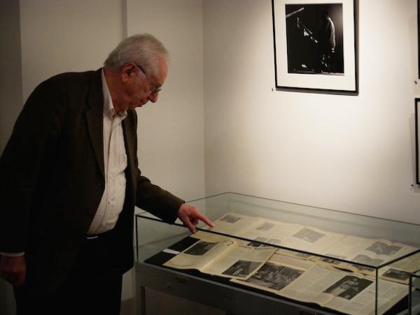 Marcel Fleiss devant l'une des vitrines de l'exposition montrant des exemplaires originaux de Jazz Hot © Jérome Partage